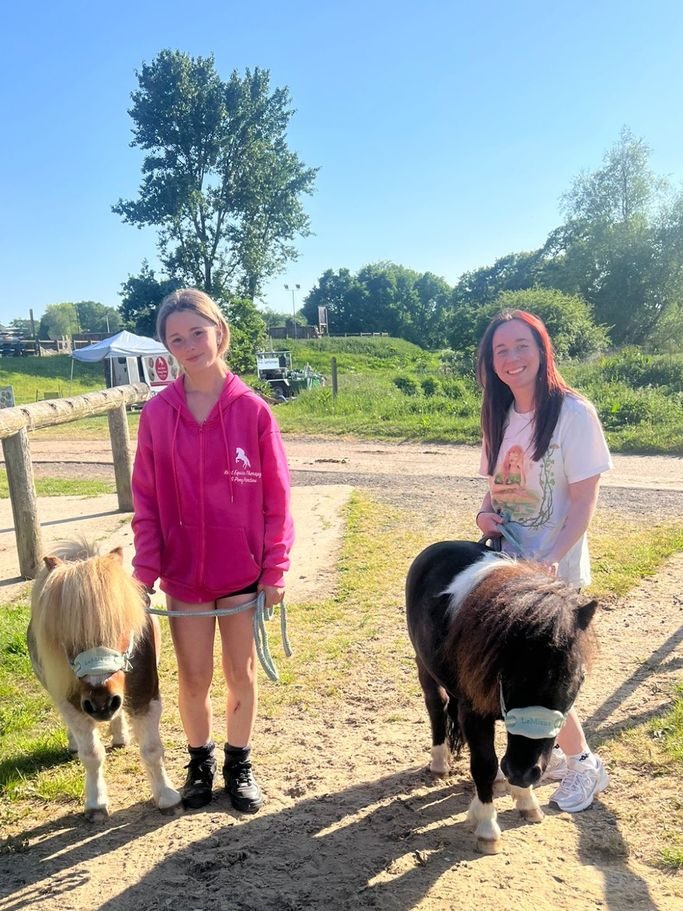 Kent Equine Therapy Ponies team with two Shetland therapy ponies outdoors in Kent